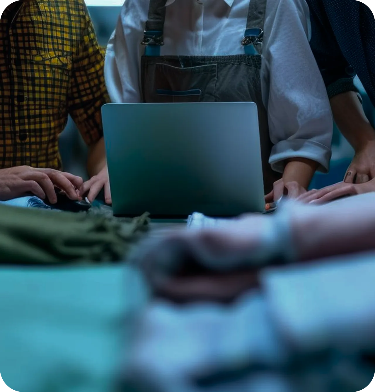 Team reviewing an order on a laptop beside fabric samples