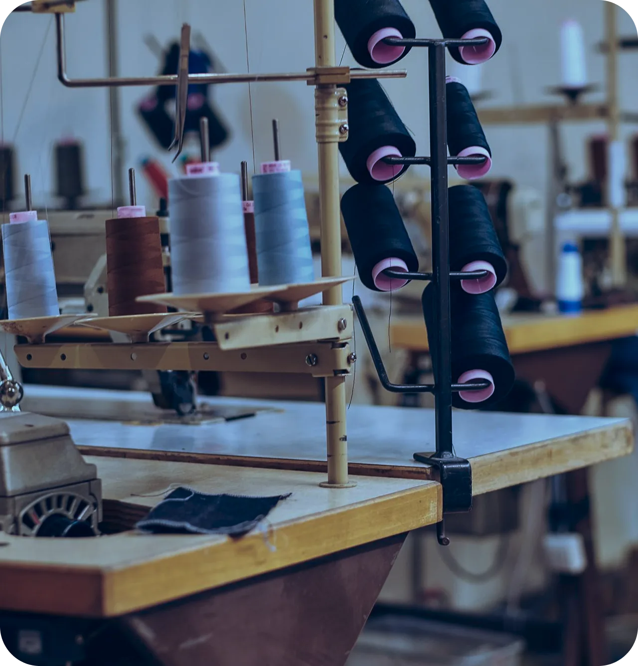 Industrial sewing machine threaded with spools of thread